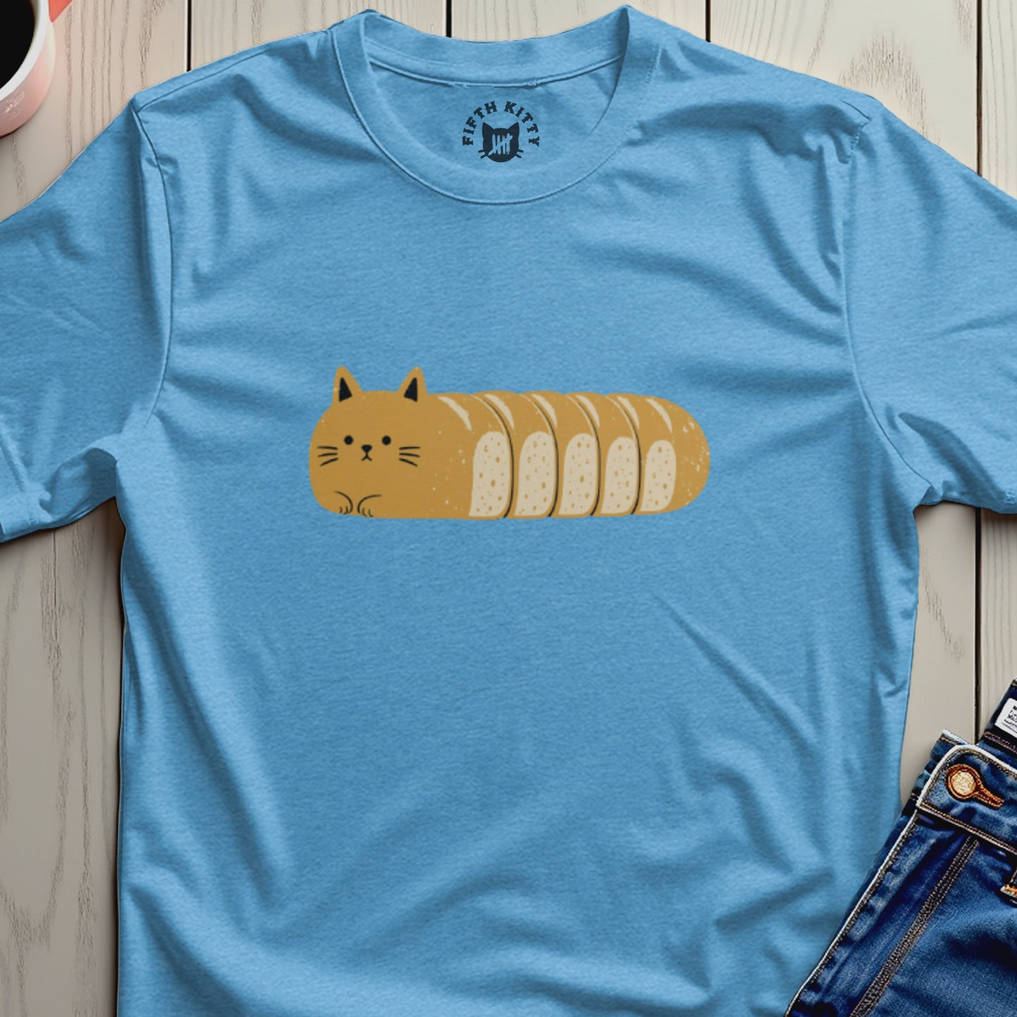 Light blue t-shirt with a cartoon cat-loaf of bread design and "Fifth Kitty" logo.