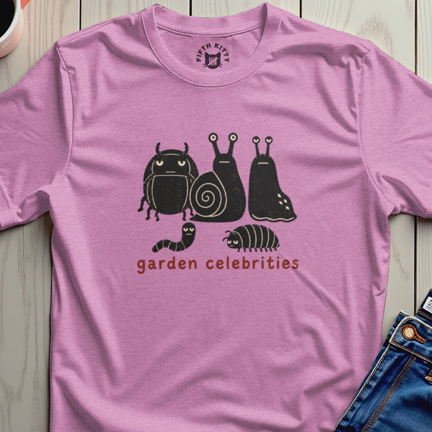 Pink t-shirt with a graphic of cartoon bugs and snails and the text "garden celebrities."