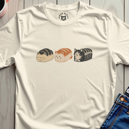 Cream t-shirt with a graphic of three loaf-shaped cats in a row.