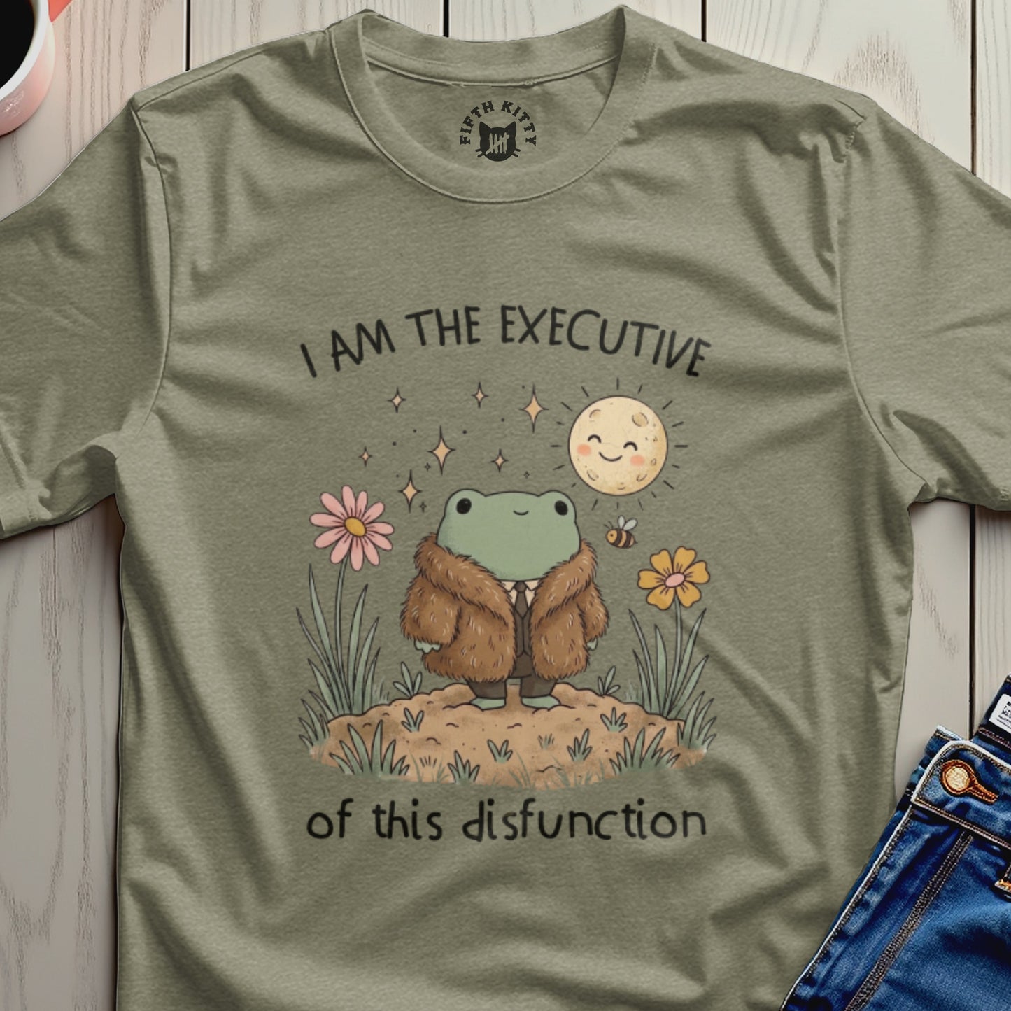 T-shirt with a frog wearing a fur coat, moon, flowers, and text.