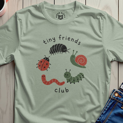 Light green t-shirt with "tiny friends club" text and cartoon insects.
