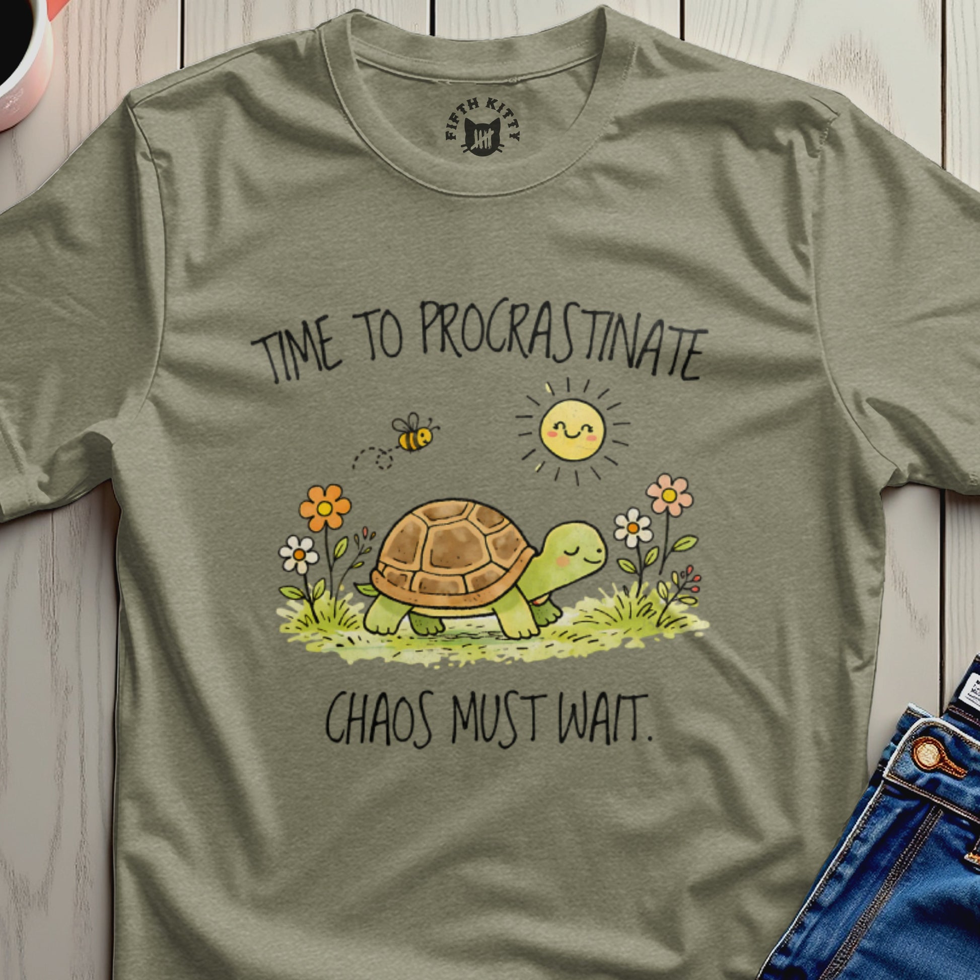 Turtle with "Time to Procrastinate" and "Chaos Must Wait" text on a t-shirt.