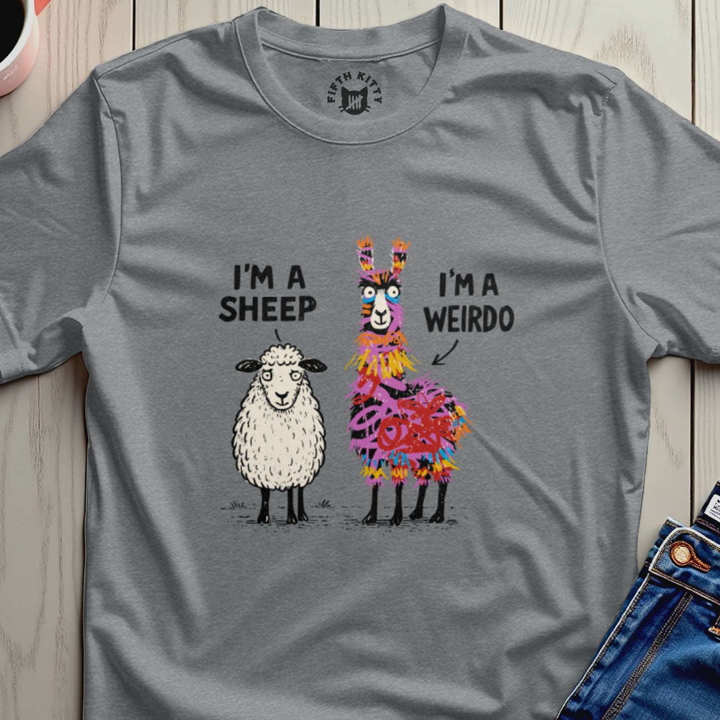T-shirt with a cartoon sheep and a colorful llama, text reads "I'm a sheep I'm a weirdo".