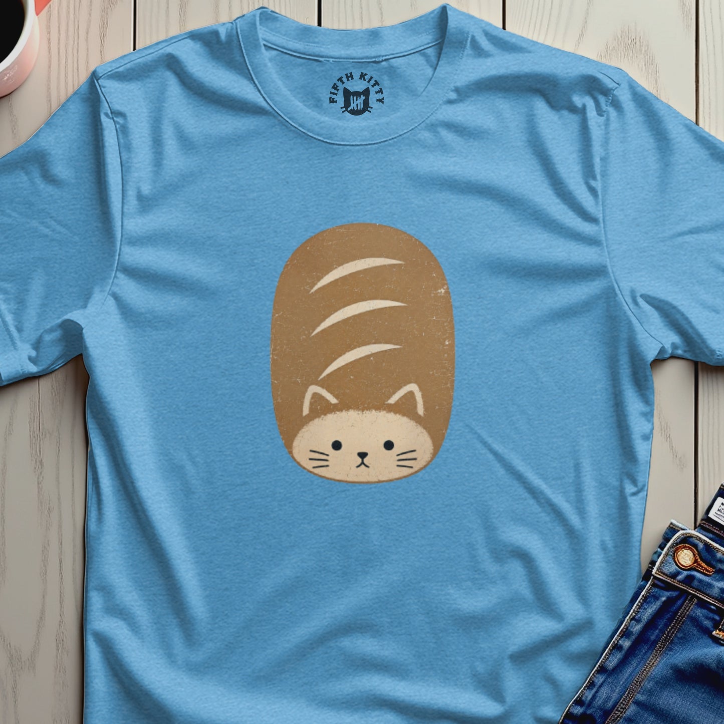 Light blue t-shirt with a cartoon cat-loaf graphic and "Fifth Kitty" logo.