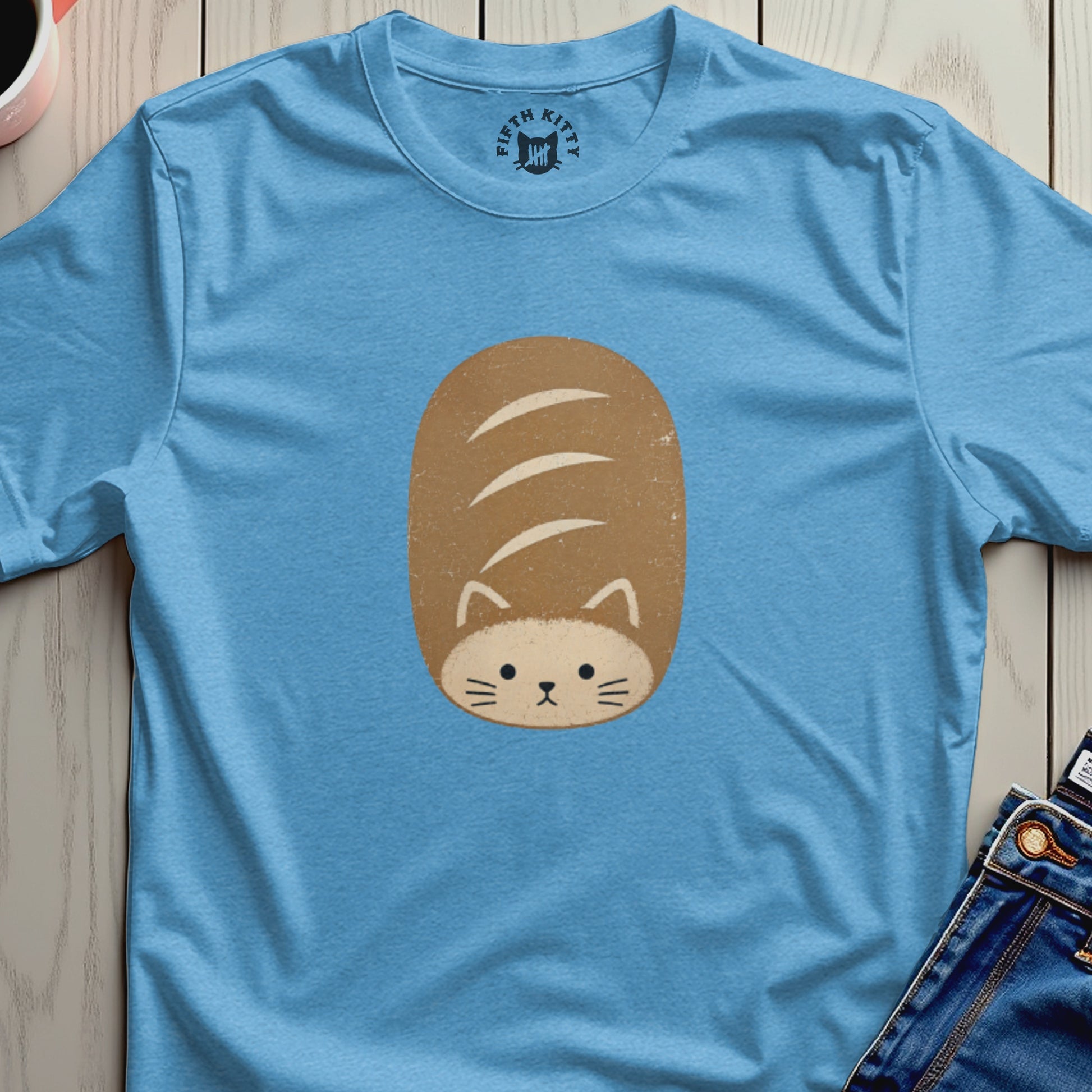 Light blue t-shirt with a cartoon cat-loaf graphic and "Fifth Kitty" logo.