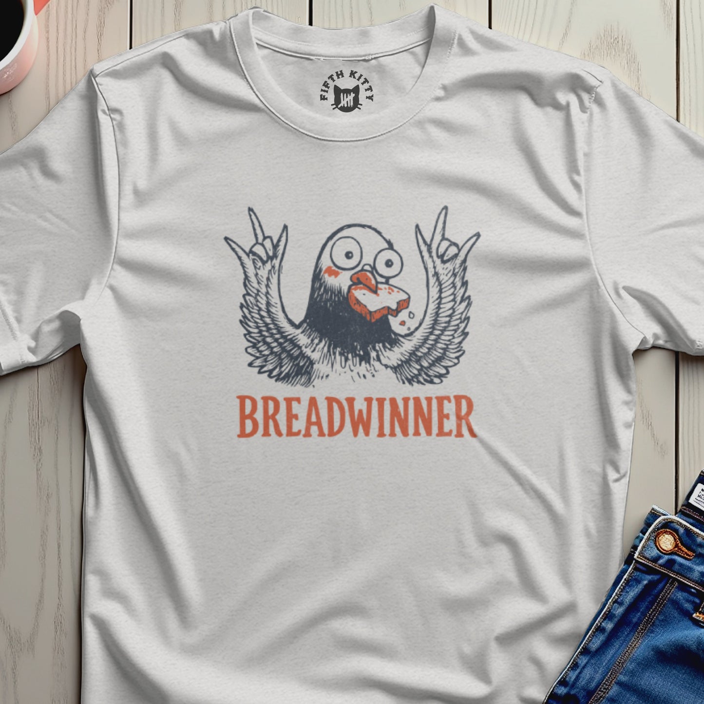 T-shirt with a cartoon bird with wings spread holding bread in its beak, text reads "Breadwinner".
