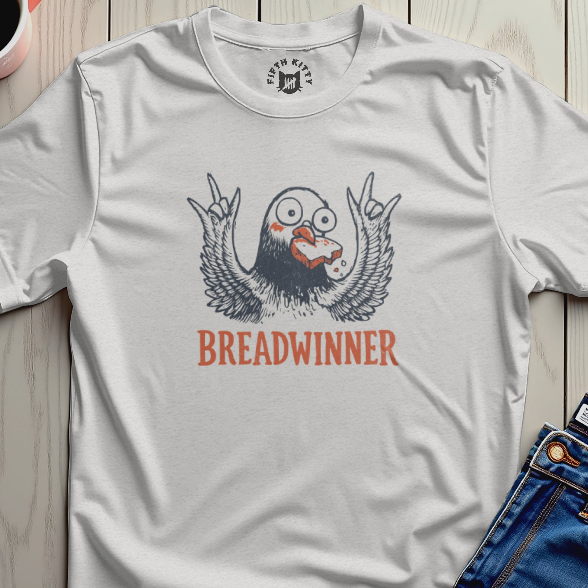 T-shirt with a cartoon bird with wings spread holding bread in its beak, text reads "Breadwinner".