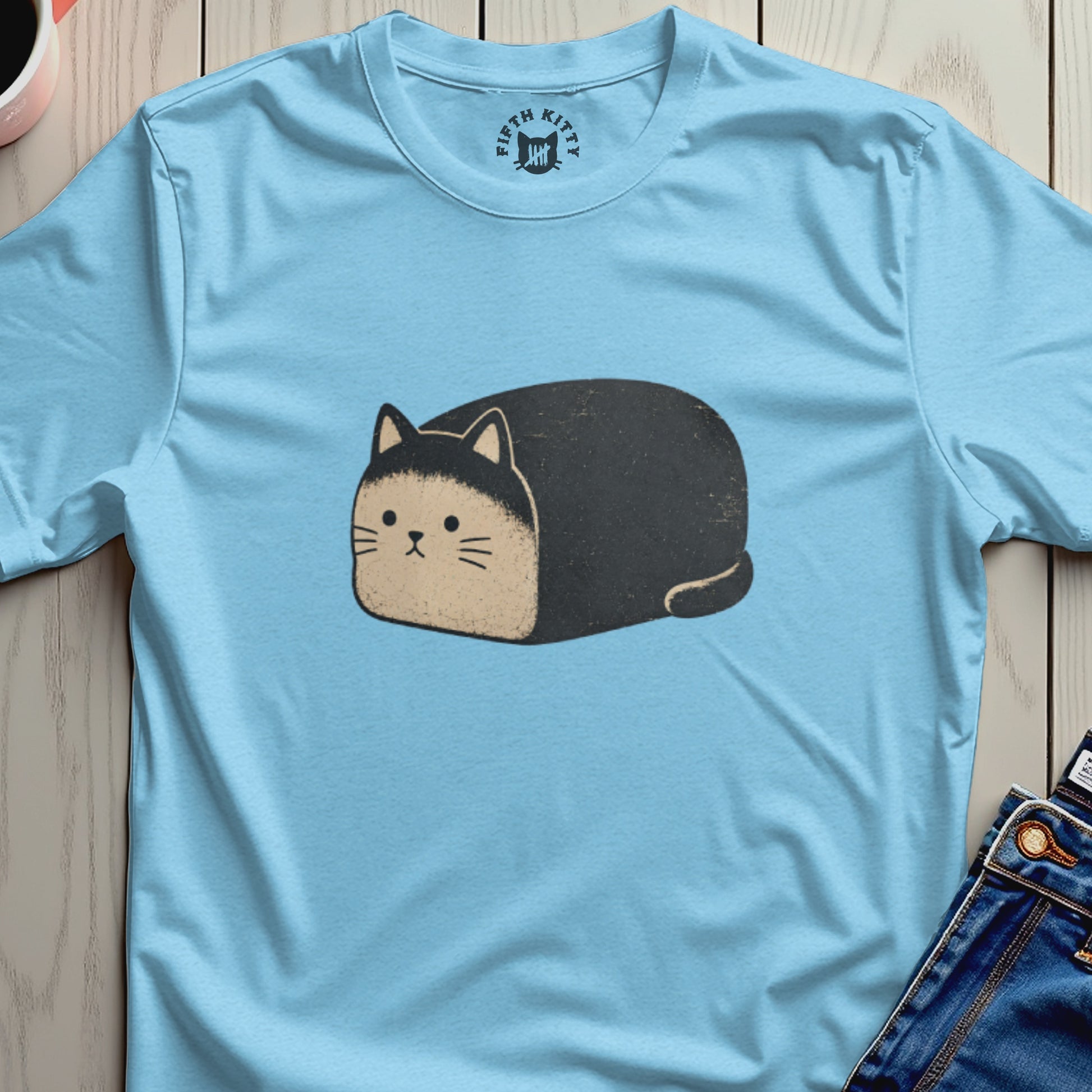Light blue t-shirt with a distressed illustration of a black and tan loaf cat.